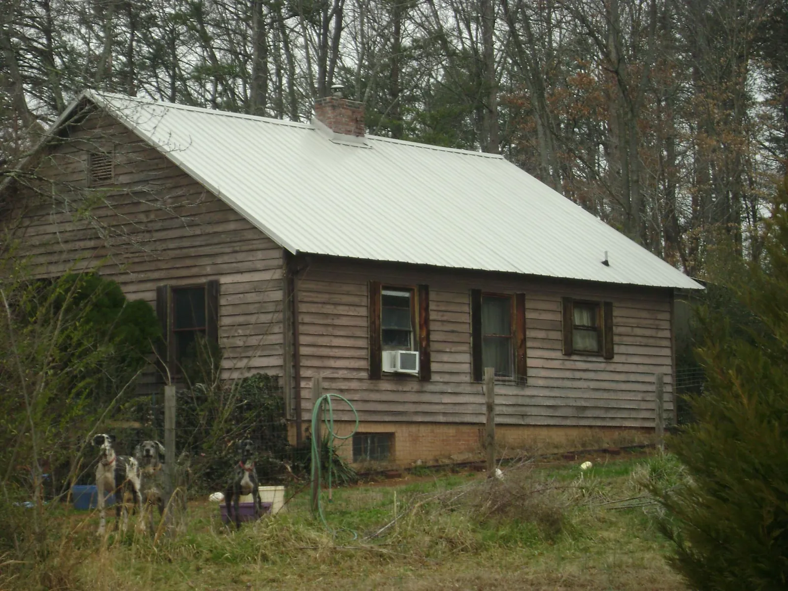 White metal roof on an old wood sided farmhouse, from a Metal Roof Installation job in Center Line